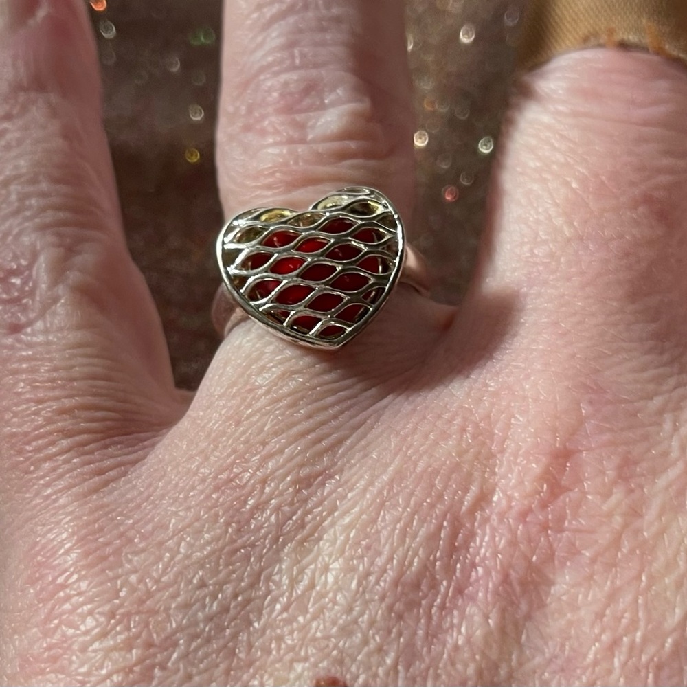 Sterling silver ring with a red back ground.